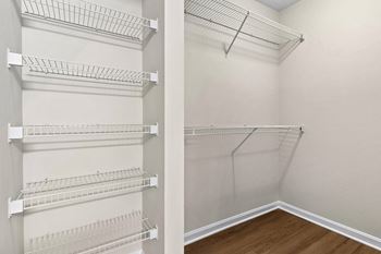 Walk-in closet with wire shelving and hanging storage